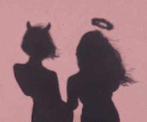 the shadow of two women standing next to each other