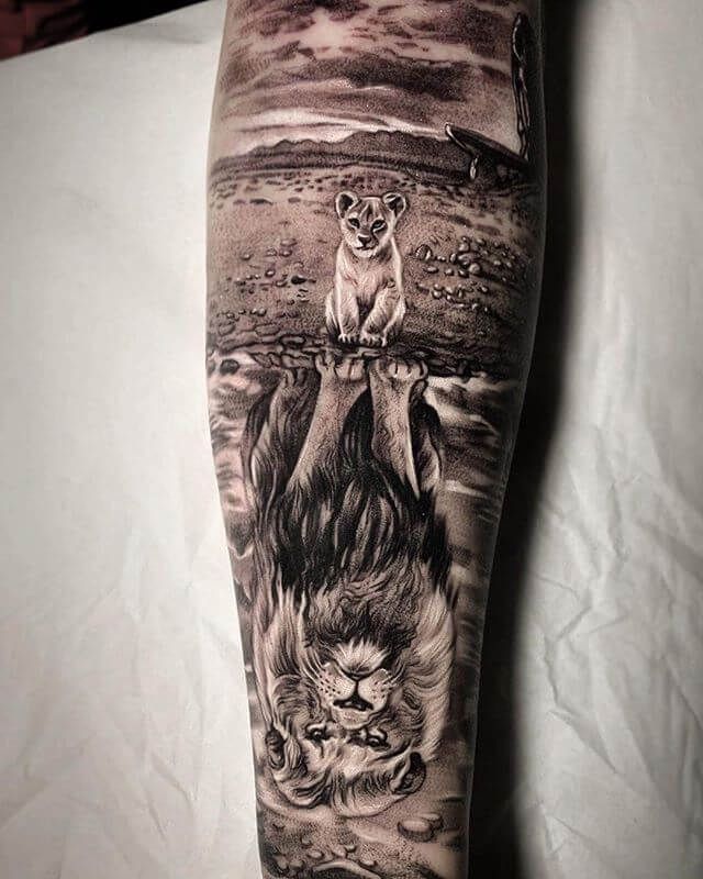 a man's leg with an animal tattoo on it, and the image of a lion