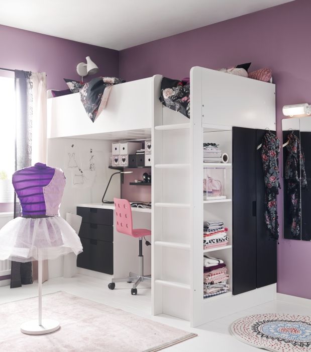 a room with purple walls and white furniture