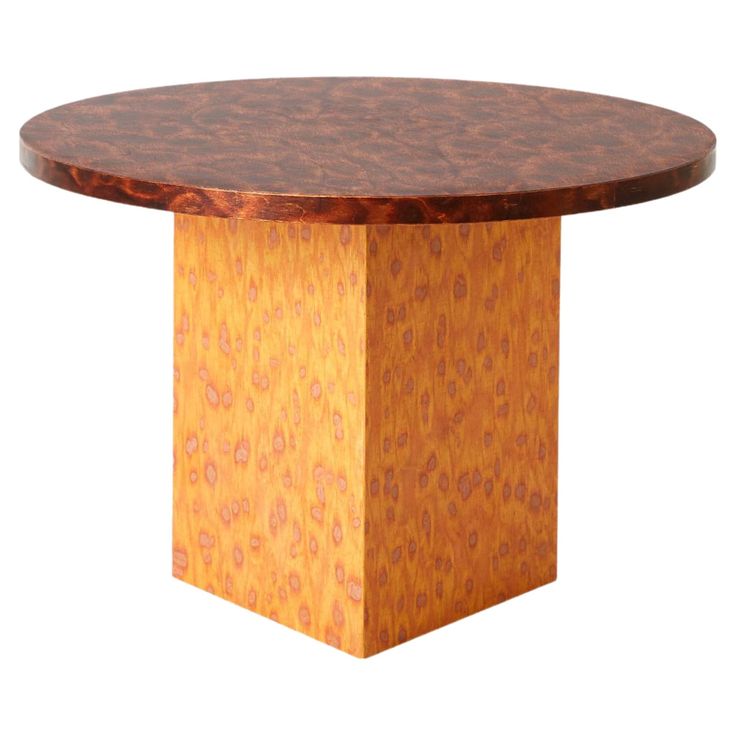 a round wooden table with an intricate pattern on it