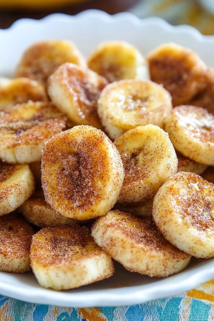 a white bowl filled with sliced bananas on top of a table