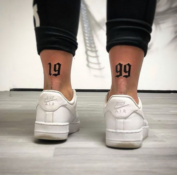 a person's feet with the number 19 tattooed on their left ankle and foot