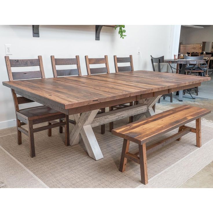 a wooden table and bench in a room