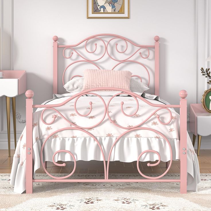 a pink metal bed in a white room with a painting on the wall behind it