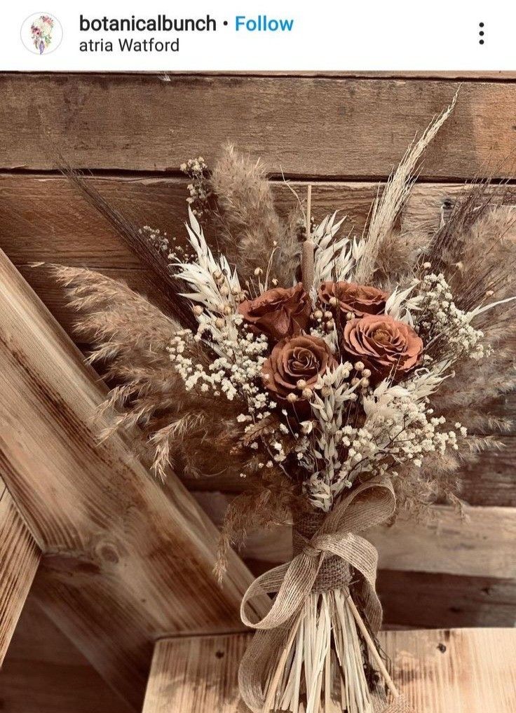 a bouquet of flowers sitting on top of a wooden table