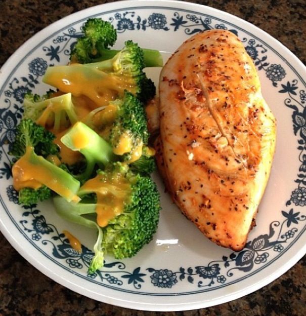 a white and blue plate topped with fish and broccoli