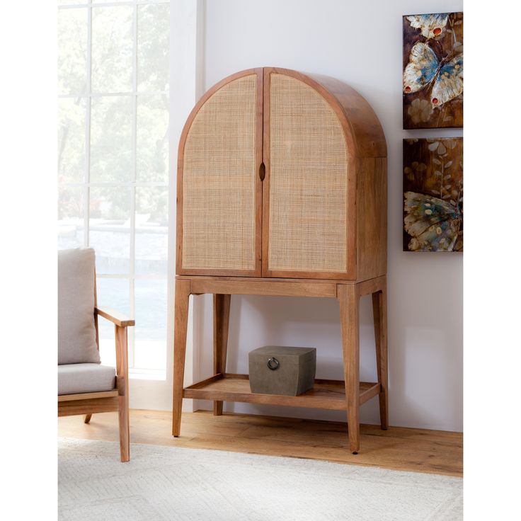 a wooden cabinet sitting on top of a hard wood floor next to a white rug