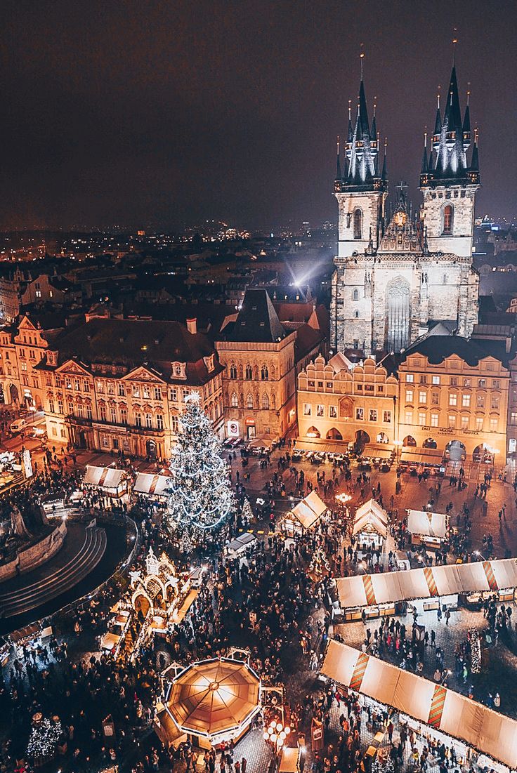 an aerial view of the christmas market in prague, germany at night with lights on