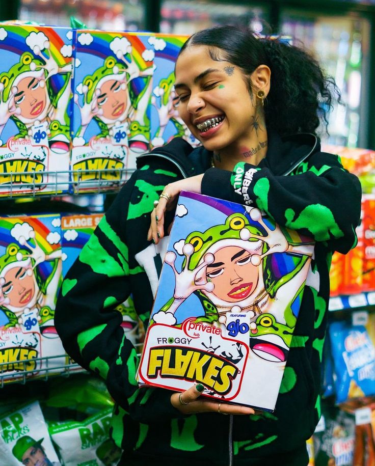 a woman is smiling while holding a bag in front of boxes of cereal and candy