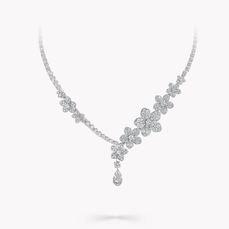 Beautifully articulated to burst with life upon the décolletage, our Wild Flower diamond drop necklace blooms with an irresistible beauty. Handcrafted in white gold, different varieties of pavé flowers flourish in combination, with each petal uniquely rendered to burst with life. Suspended beneath, a beautifully crafted round and pear shape solitaire take centre stage, designed to be worn in profusion. The Wild Flower collection is an invitation to escape into a garden that grows just for you. From trios and individual blooms to floral clusters and blossoms laid out in a row, each Wild Flower jewel is a statement of delicacy and of empowerment. An enchanting Wild Flower diamond necklace with a total weight of approximately 7.19 carats Luxury Cubic Zirconia Flower Pendant Diamond Necklace, Luxury Engraved Diamond Necklace, Dazzling Diamond Necklace, Necklace Styling, Diamond Shaped Engagement Ring, Large Diamond Rings, Graff Diamonds, Diamond Drop Necklace, The Bling Ring