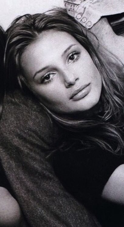 a black and white photo of two women laying next to each other