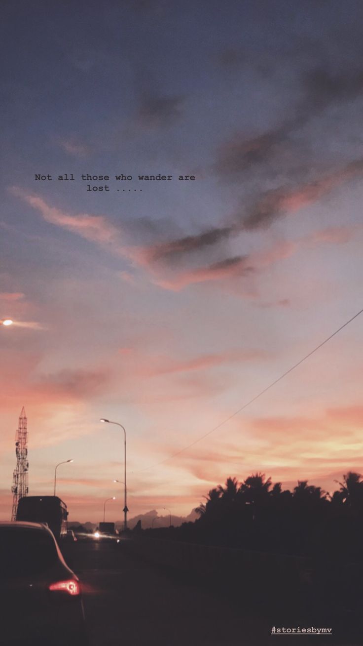 cars driving down the road at dusk with a quote above them that reads, not all those who wander are