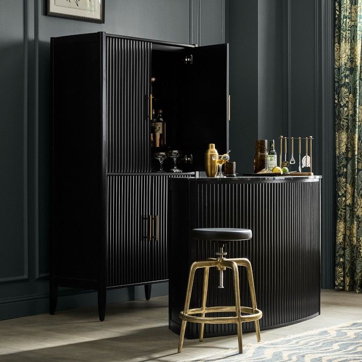 a bar with stools in front of it and an open cabinet next to it