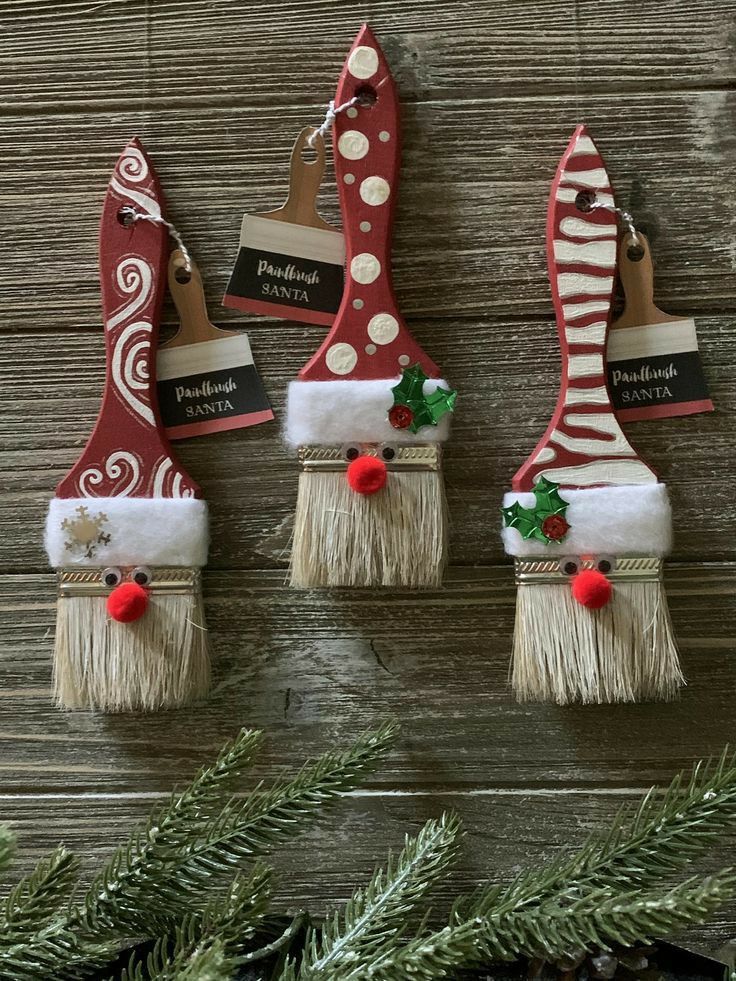 three christmas decorations hanging on a wooden wall