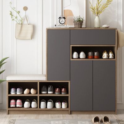 a cabinet with shoes on it next to a potted plant and some other items