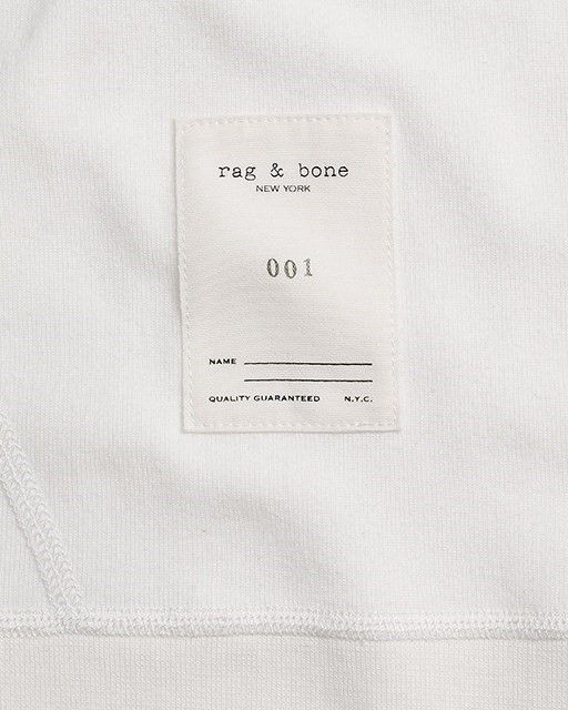 tag and bone label on the back of a white t - shirt with black lettering