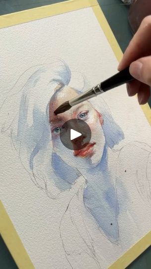 someone is painting a woman's face on paper