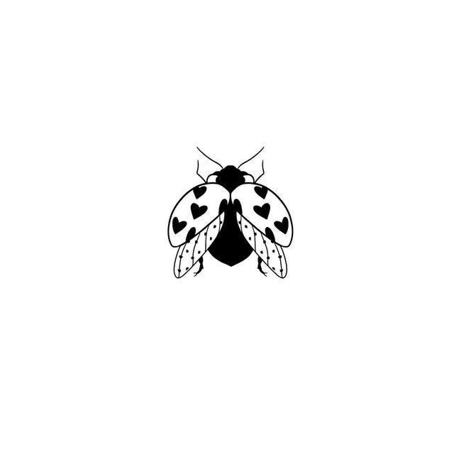 a black and white insect with hearts on it's wings