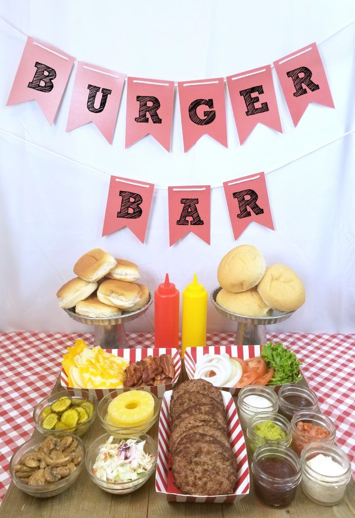 a table topped with lots of food and buns