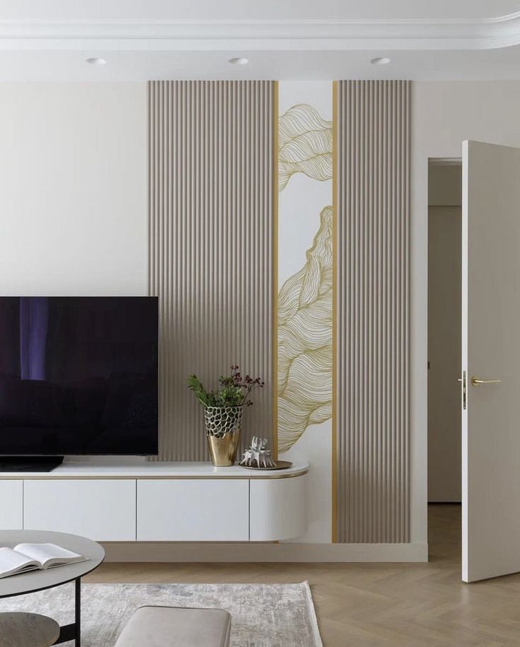 a large flat screen tv mounted to the side of a wall in a living room