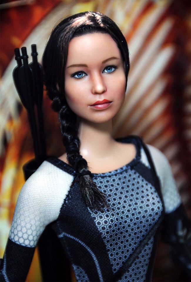 a doll with long black hair and blue eyes is holding a bow in her hand