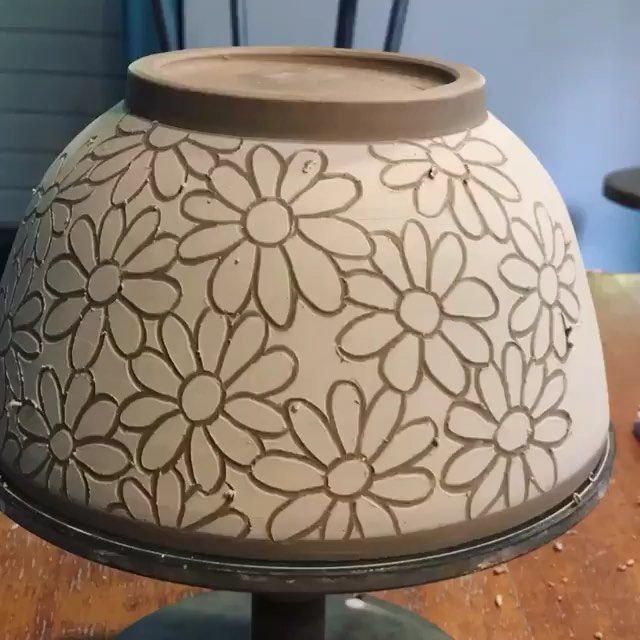 a lamp that is sitting on top of a wooden table with flowers painted on it