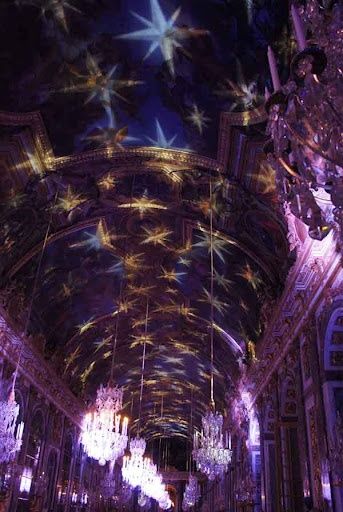 the ceiling is decorated with lights and chandeliers