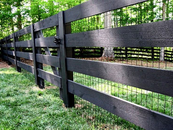 a black fence is shown in the grass