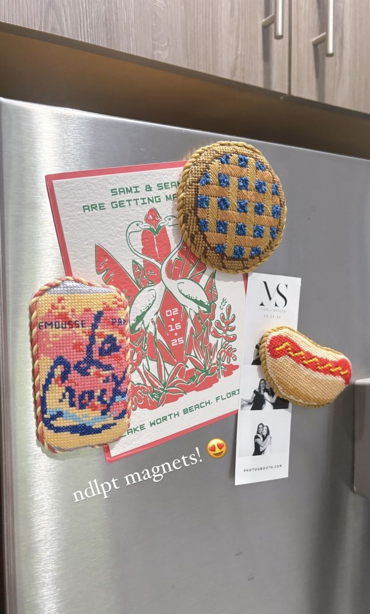 magnets on the side of a refrigerator with hot dogs and buns attached to it