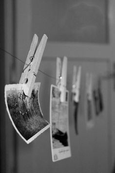 clothes pins hanging on a line with pictures hung to dry in front of the door