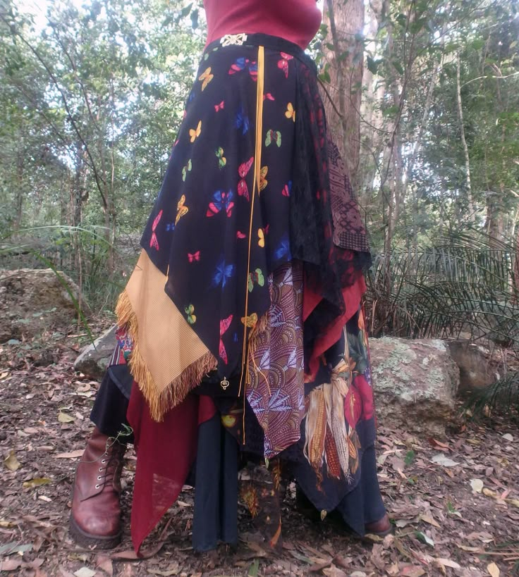 This multi-layered wrap skirt features a large butterfly theme fabric piece, as well as a range patterned and ornamented polyester, jersey and chiffon on a silky taffeta backing. Ornamental embellishments are also incorporated. The garment particularly suits day wear celebrations and events. The skirt fits sizes 8 to 18. The length from waist band to longest fabric drop is approximately 106cm. Owing to its length the skirt is best worn with boots so as to give better ground clearance. Garment fa Multi Layered Skirt, Diy Layered Skirt, Skirt Made Of Ties, Patch Skirt Outfit, Patch Work Clothes, Witch Glam, Plants Indoor Decor, Eclectic Outfit, Multifunctional Clothing