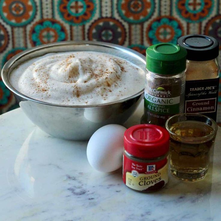 ingredients to make an eggnog recipe sitting on a table next to a bowl