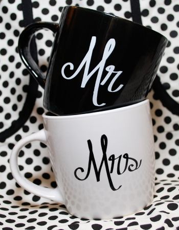 two black and white coffee mugs with mr and mrs written on them