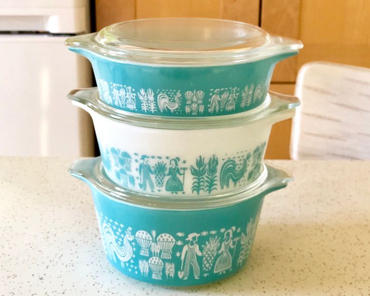 three blue and white casserole dishes stacked on top of each other