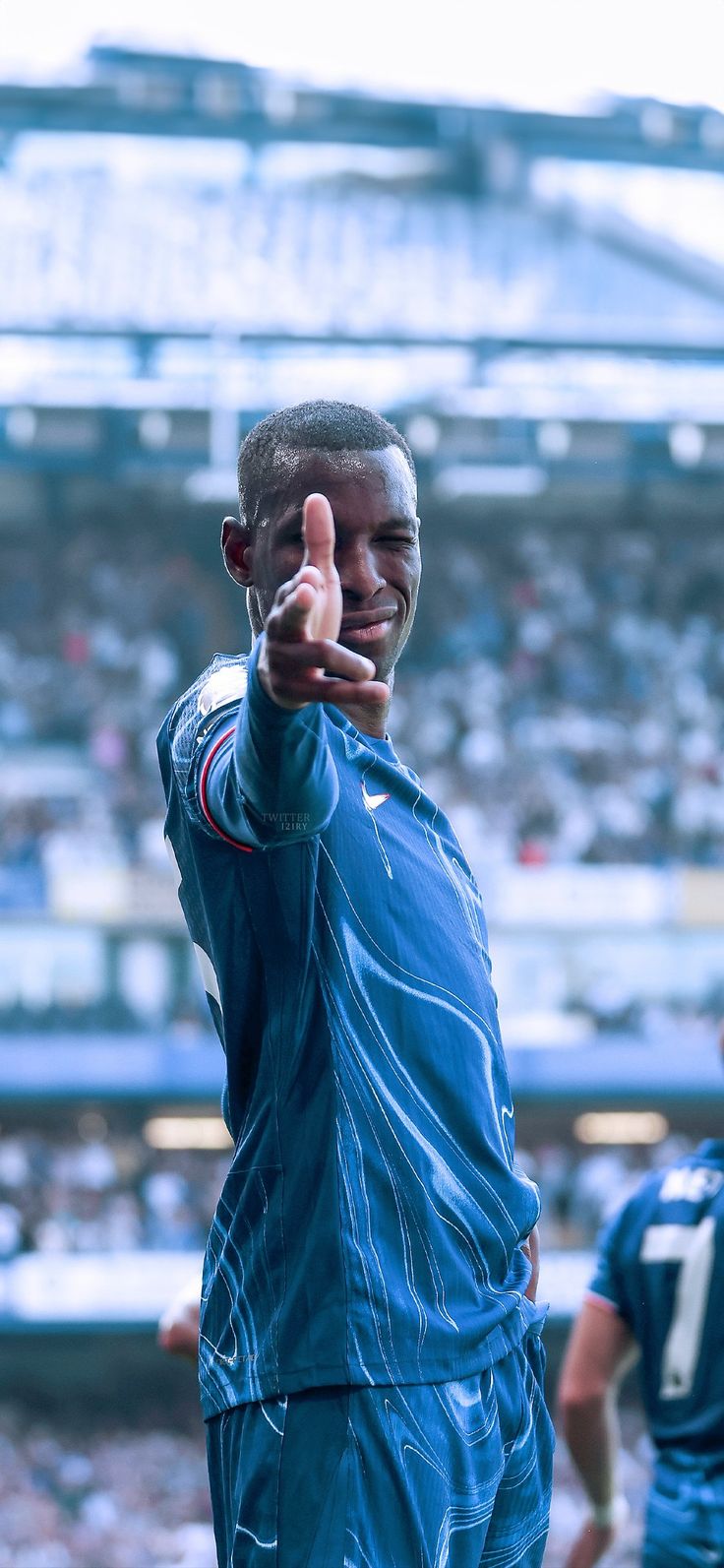 a man giving the thumbs up sign at a football game