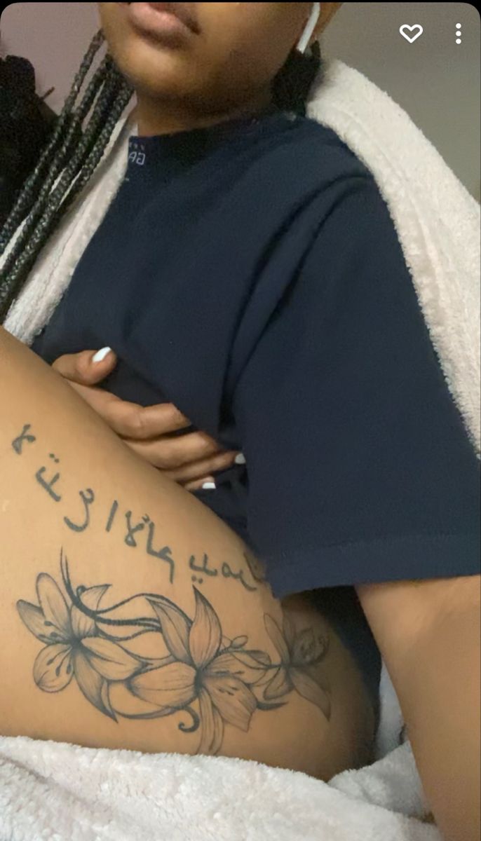 a woman with a tattoo on her thigh and the words written in arabic are shown