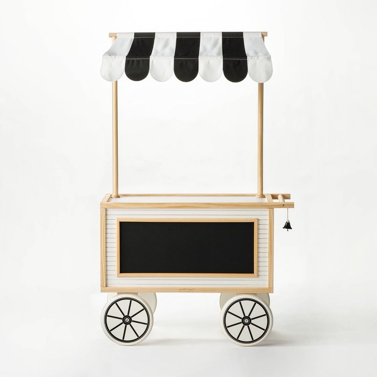 an ice cream cart with black and white awnings on the top, sitting in front of a white background