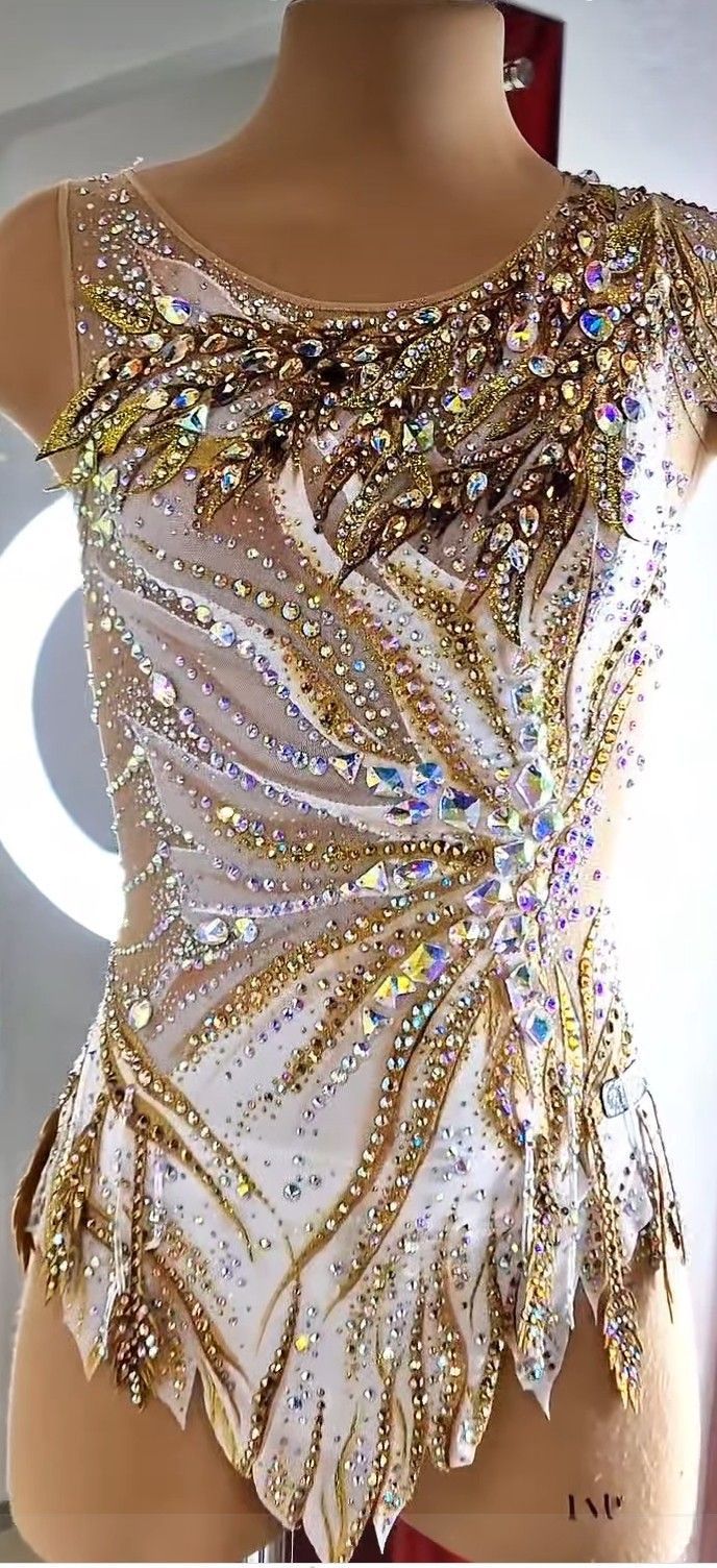 a mannequin is dressed up in gold and white clothing with sequins