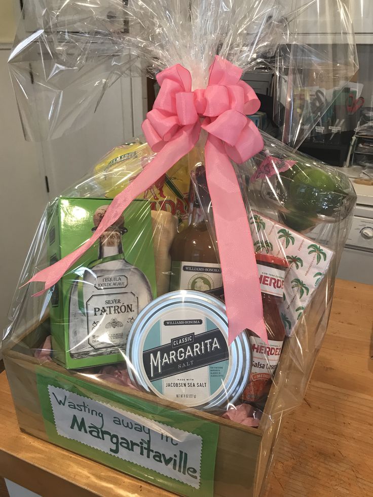 a large gift basket with personal care items in it on a wooden table next to an oven