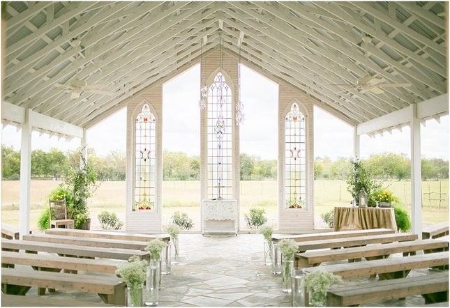 the inside of a church with pews and flowers