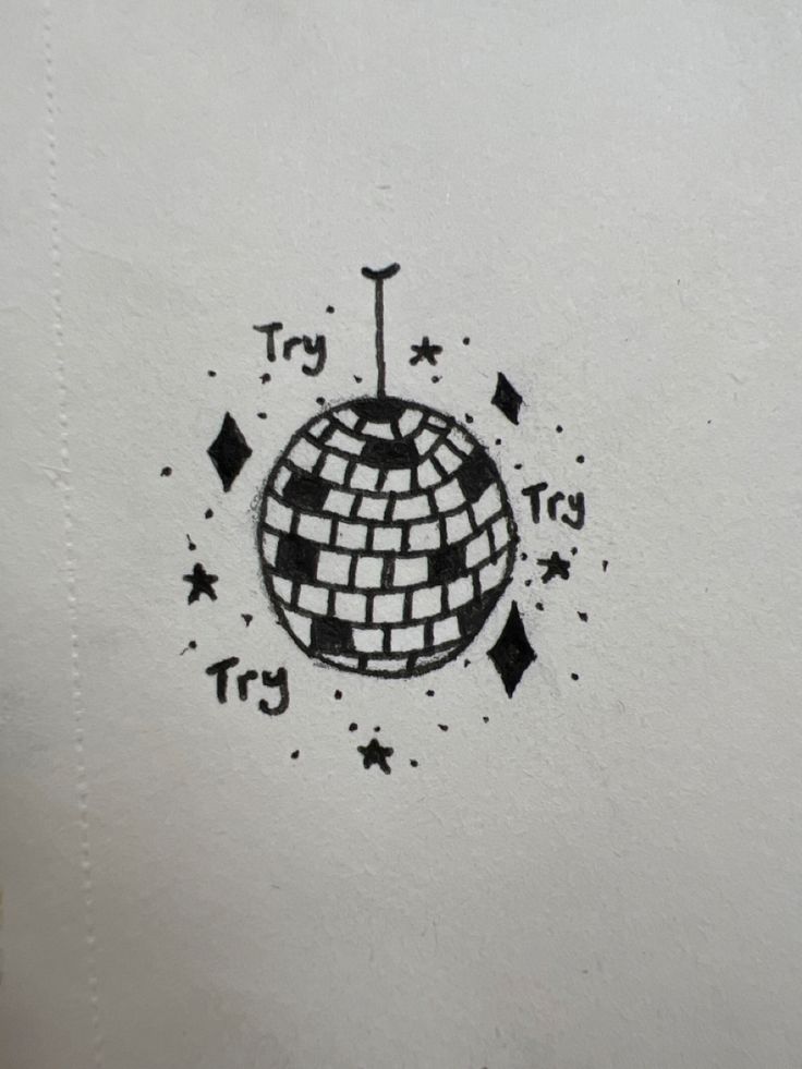 a black and white drawing of a disco ball with stars around it on a piece of paper