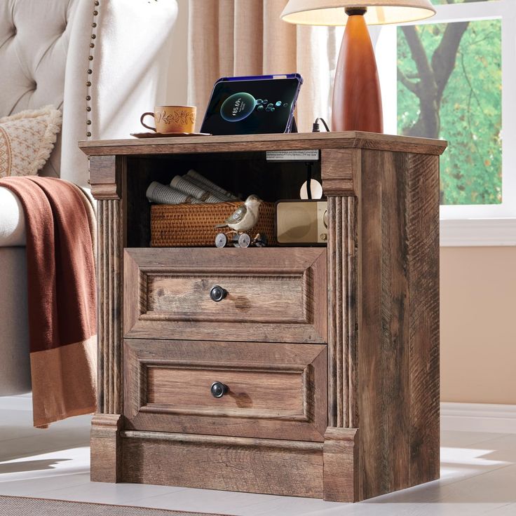 a wooden cabinet with two drawers and a laptop on top