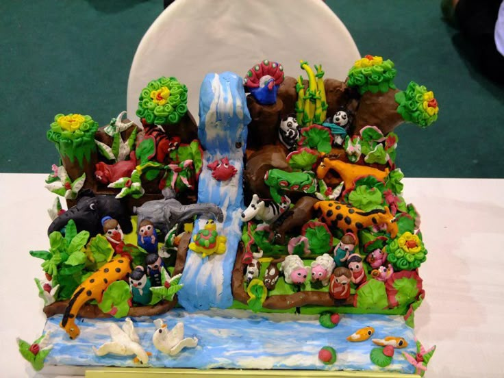 a cake that looks like it is made to look like an island with animals on it