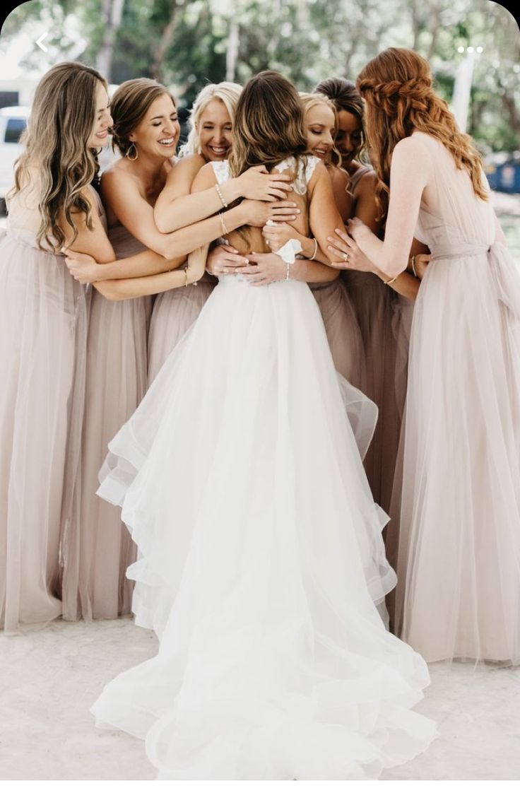 a group of bridesmaids hugging each other