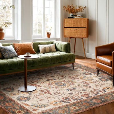 a living room with two couches and a rug in front of the window,