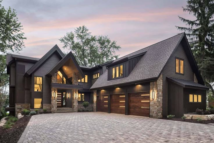 a large house with lots of windows and brick driveway