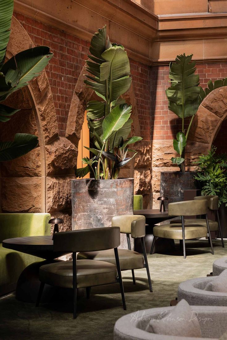 the interior of a restaurant with tables, chairs and potted plants