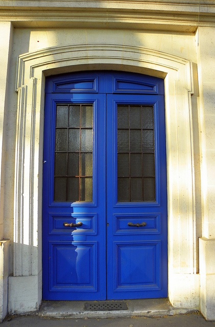 a large blue door is in front of a building