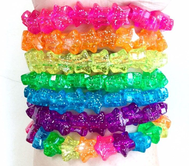 Colorful, sparkling stars in six solid colors and one rainbow! The base of each bracelet is a 6.75-inch strong and stretchy elastic jewelry cord. All beads are plastic. Rainbow Bracelet Beads, Decora Accessories, Glittery Jewelry, Elastic Jewelry, Dreams Core Aesthetic, Rainbow Accessories, Kandi Cuff, Kandi Bracelets, Bead Charms Diy