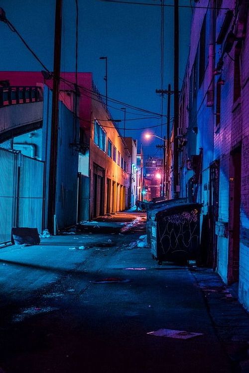 an alleyway at night with neon lights and graffiti on the walls, in front of buildings